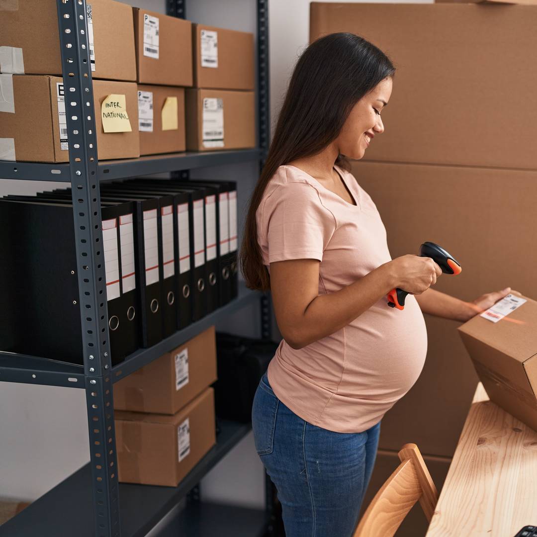 Pregnant woman scanning boxes