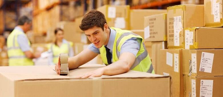 The Pros and Cons of Warehouse work : Male Warehouse Operative sealing box