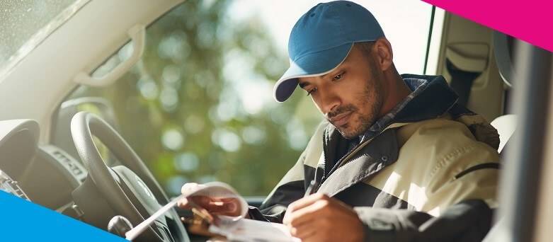 A Driver on shift completing documentation in the vehicle following a delivery