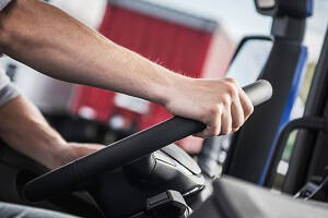 What I've learnt from being a Class 2 Truck Driver? Blog image - Close up of a Driver steering the steering wheel