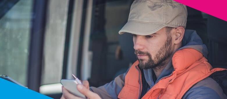 Image of a Driver in a stationary vehicle viewing informaiton on a device