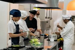 Group of chefs preparing vegetables in the kitchen