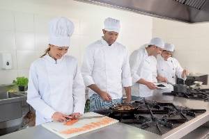 Different types of chefs preparing food in the kitchen