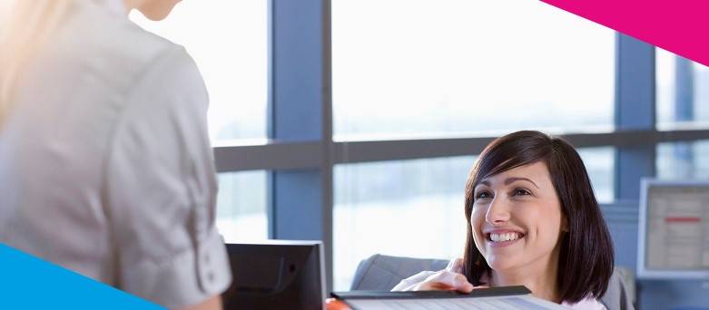 An office worker conversing with a colleague on a work task